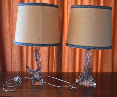 two lamps that are on a table in front of a curtain