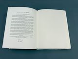 an open book on a table with a blue background