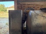 a large metal tank sitting in front of a window