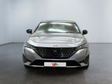 the front view of a silver car in a white room