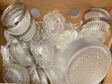 a cardboard box filled with glass dishes and cups
