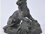 bronze statue of a lion on a rock with a white background