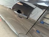 a close up of a car door handle with a hole in it