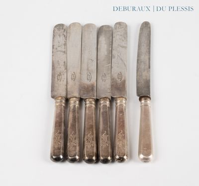 six knives are lined up in a row on a white surface