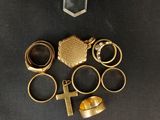 a close up of a bunch of rings and a cross on a table