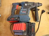 a corded drill and a corded hammer on a table