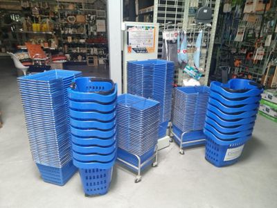 many blue plastic baskets stacked on top of each other in a store