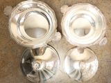 three silver candlesticks on a marble table