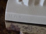 a close up of a white plate with a cat on it