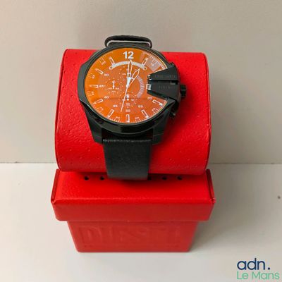 a watch that is sitting on top of a red box