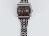 a close up of a watch on a white surface with a white background