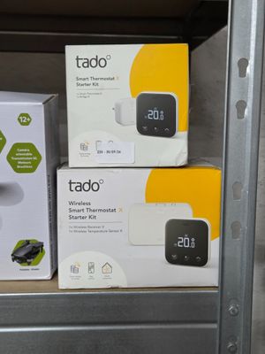 three boxes of tado products sit on a shelf in a store