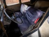 an old car with a seat and a steering wheel