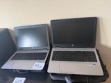 two laptops that are sitting on top of a table