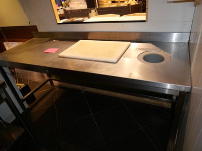 a counter with a cutting board on it in a kitchen