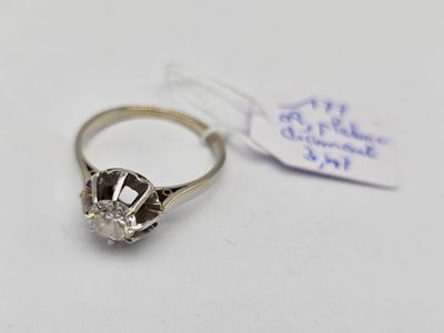 un gros plan d'une bague en diamant sur laquelle est accrochée une étiquette