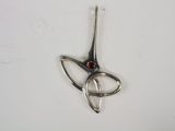 silver plated pendant with a red stone in the shape of a bird