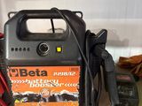 a black and orange battery charger sitting on a counter