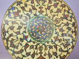 a yellow plate with a floral design on it