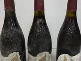 three bottles of wine that are sitting on a table