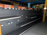 many empty shelves in a store with signs on them