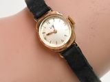 an image of a woman ' s wrist with a watch on it