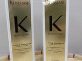 two bottles of kerastasee hair care sitting on top of a basket