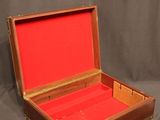 a wooden box with a red lining inside of it
