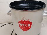 a crock pot with a sticker on it sitting on a counter