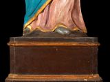 an antique statue of a woman holding a baby in her arms