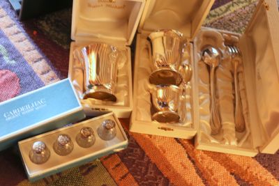 a box of silverware sitting on the floor next to a pair of spoons and spoons