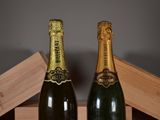 two bottles of champagne sitting next to each other on a table