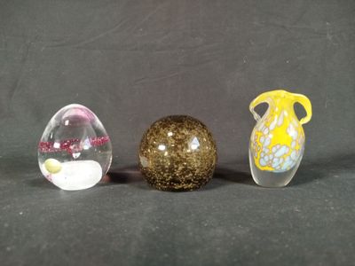 three glass vases sitting next to each other on a table