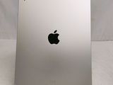 the back of a silver ipad with a black apple logo on it