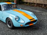 an image of a blue and orange car parked in a parking lot