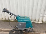 a small machine that is sitting on the side of the road