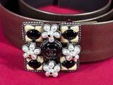 a close up of a belt with pearls on it