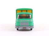 a green toy truck that is sitting on a white surface