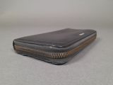 leather wallet with zipper on the inside of it sitting on a table