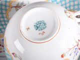 a tea pot and saucer sitting on a plate