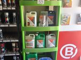 a shelf of cleaning products in a store next to a refrigerator