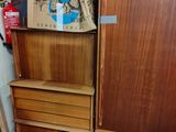 a lot of wooden furniture in this room