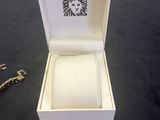 a box with a ring inside of it on a table