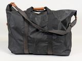 an image of a black duffel bag sitting on top of a table