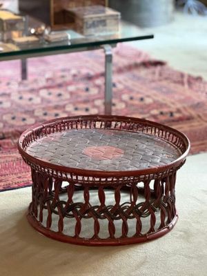 a coffee table that has a glass top on it