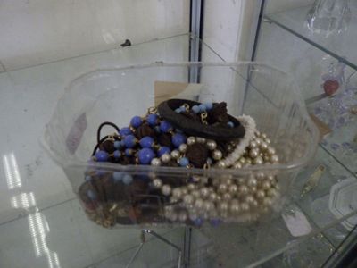 a glass display case with a bunch of jewelry in it