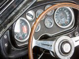 a steering wheel and gauges in the dashboard of a car