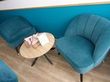 three blue chairs and a table in a room