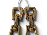 pair of gold tone metal earrings with a white cord