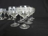 several empty wine glasses are lined up on a black table